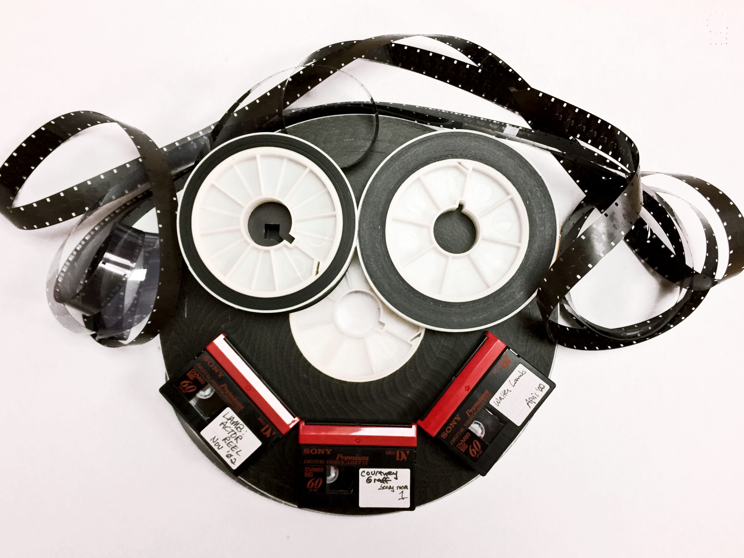 Smiling face made up of old reels of tape